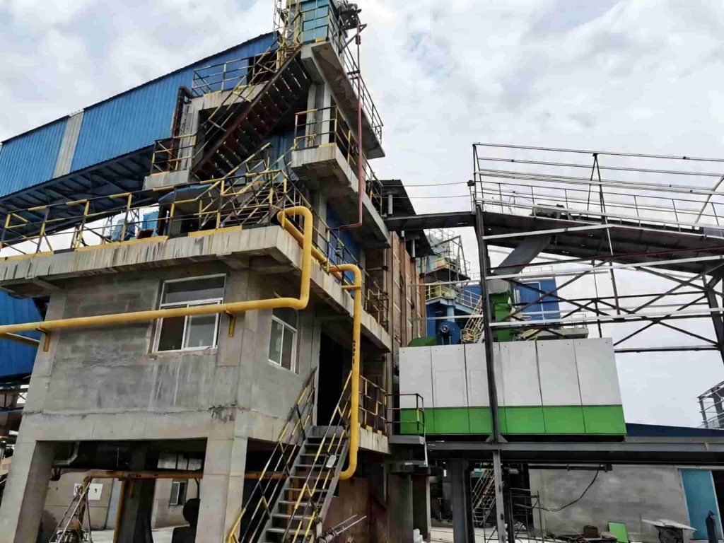 Natural gas steam boiler retrofit with wood chip burner system for industrial factory